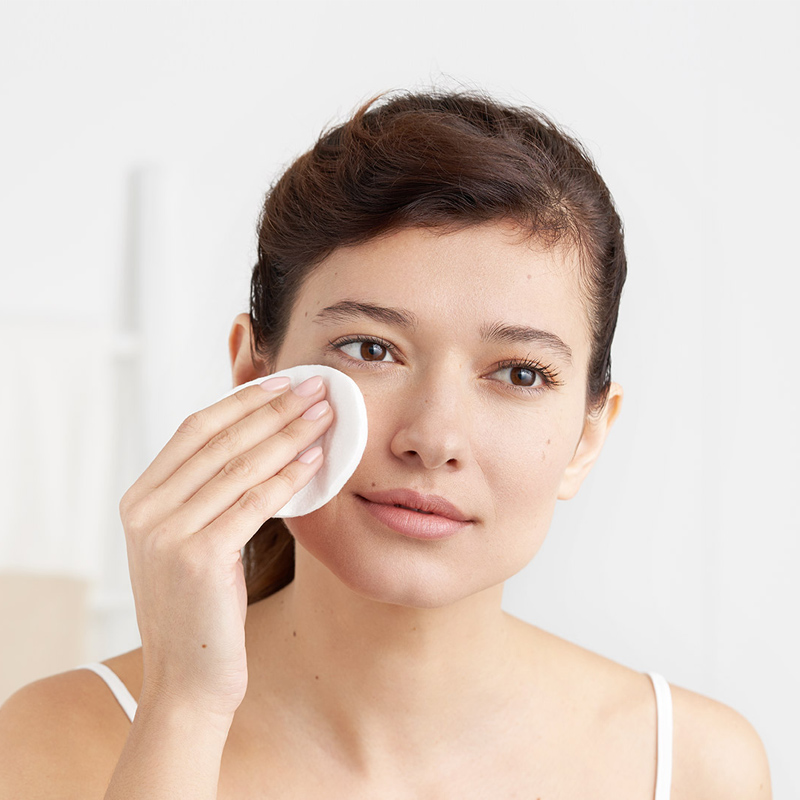 woman cleansing face